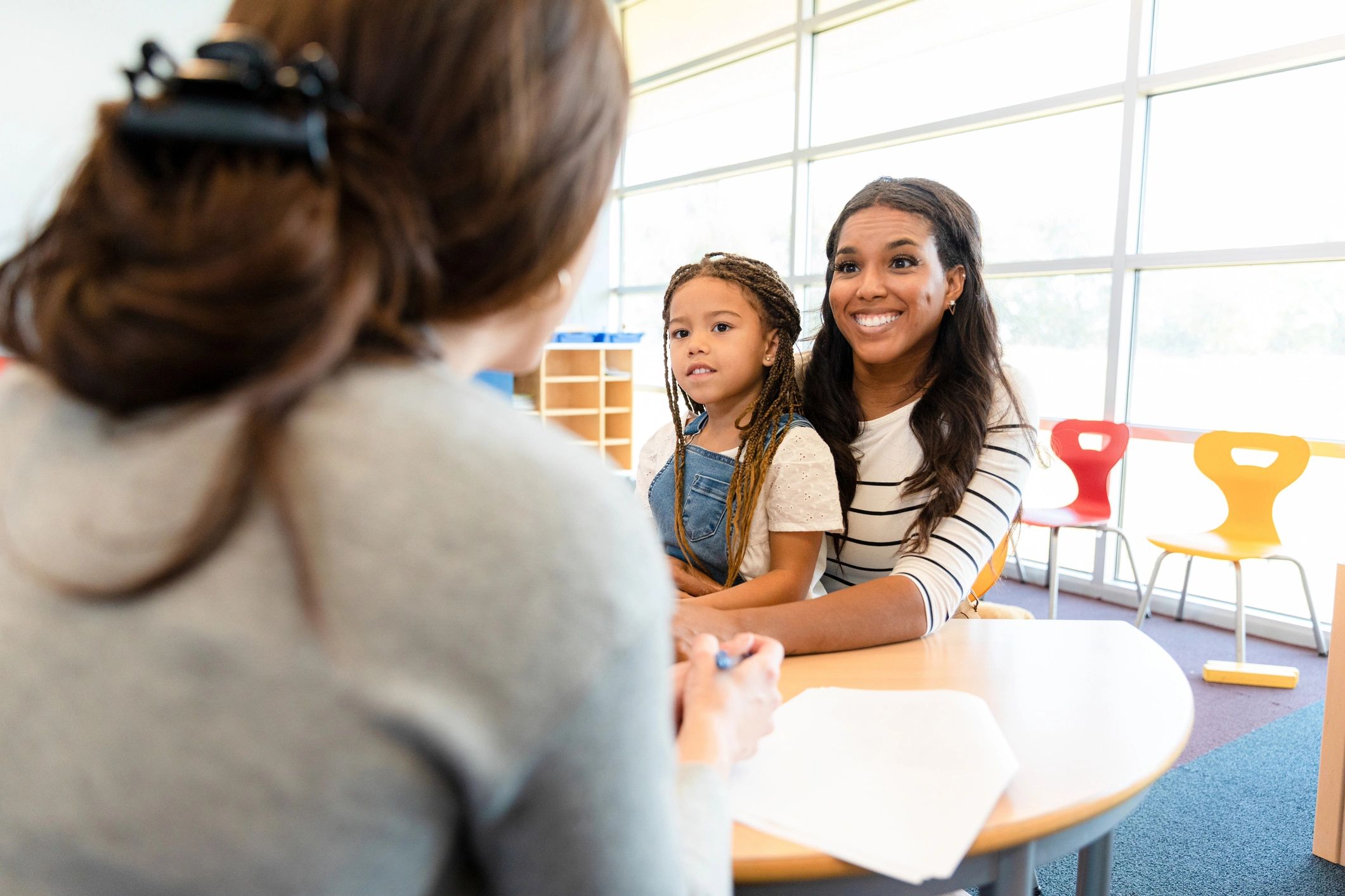 Parent meeting with a child and a therapist or specialist