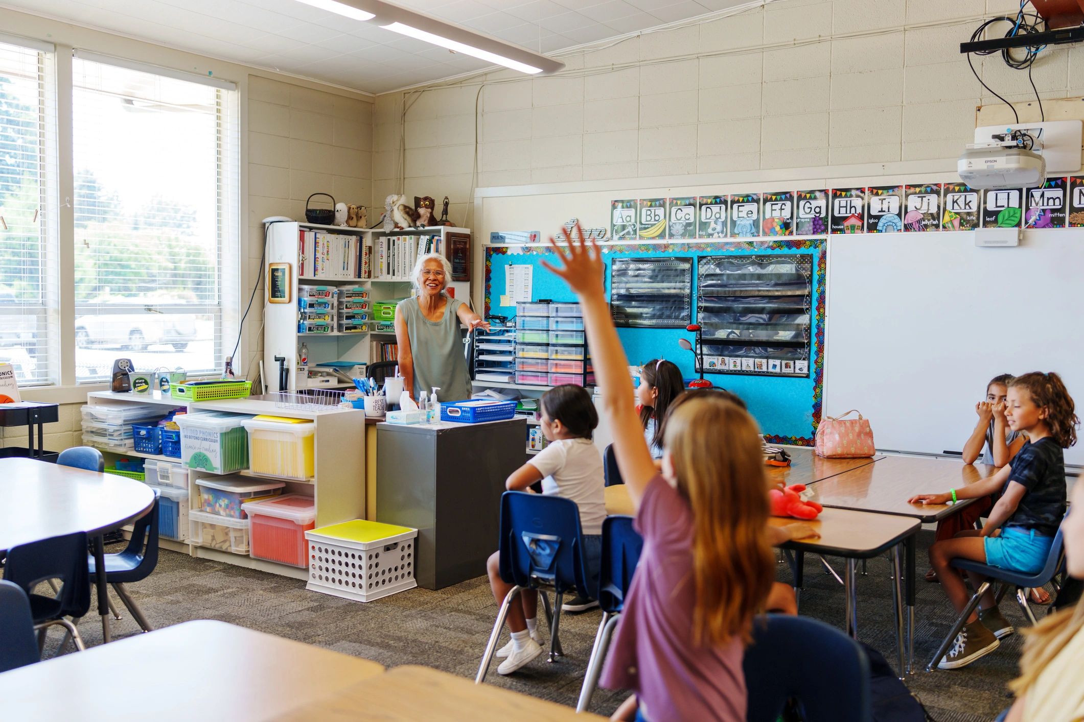 Elementary teacher answering student questions in class