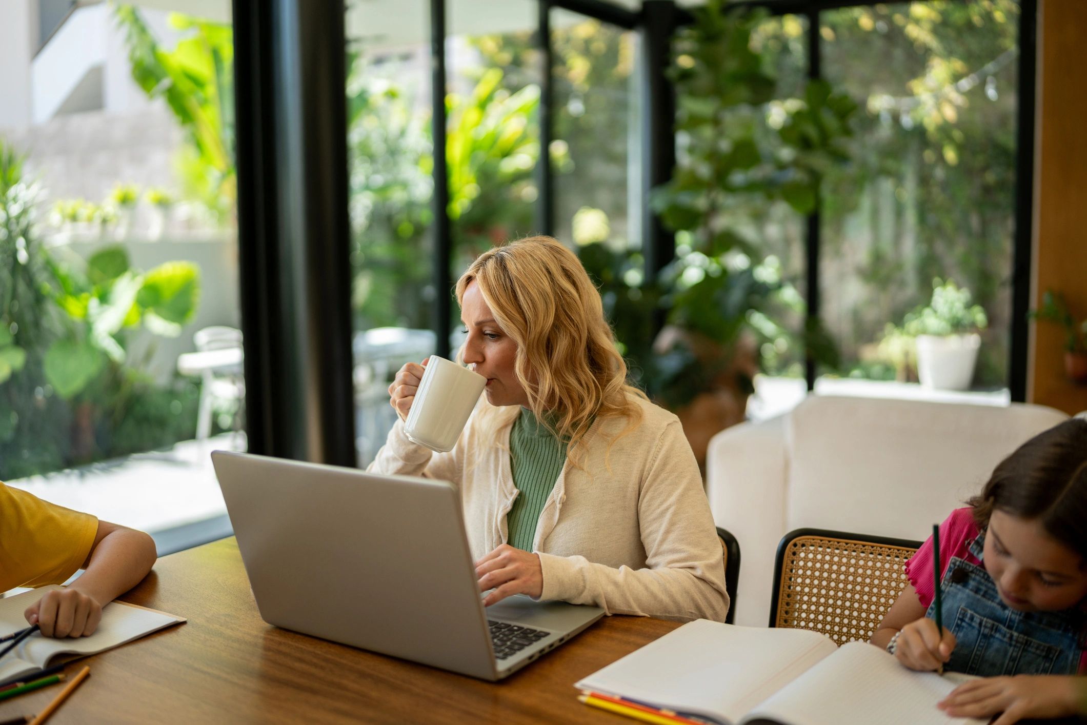 Parent working while children draw at home