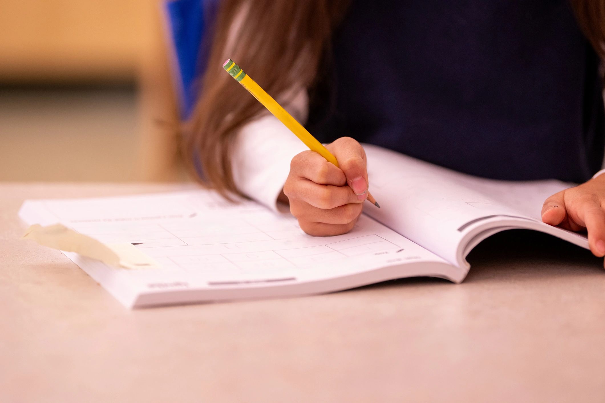Close-up of a hand writing notes in a notebook