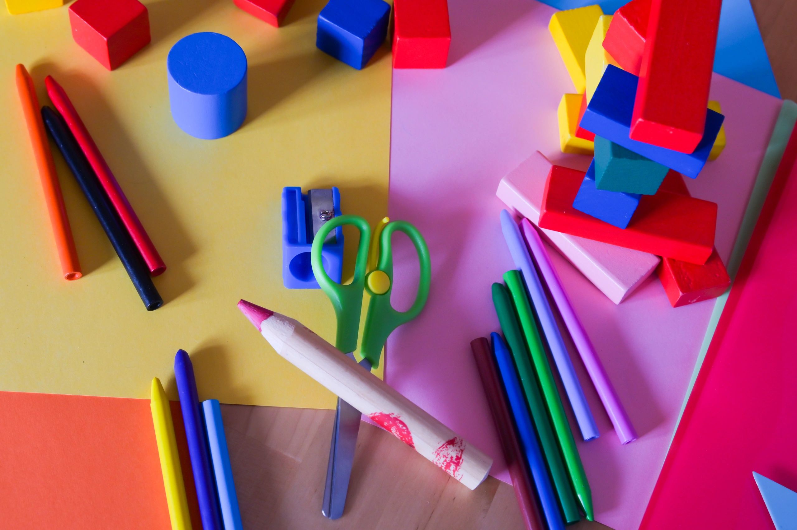 Brightly colored art supplies arranged on paper